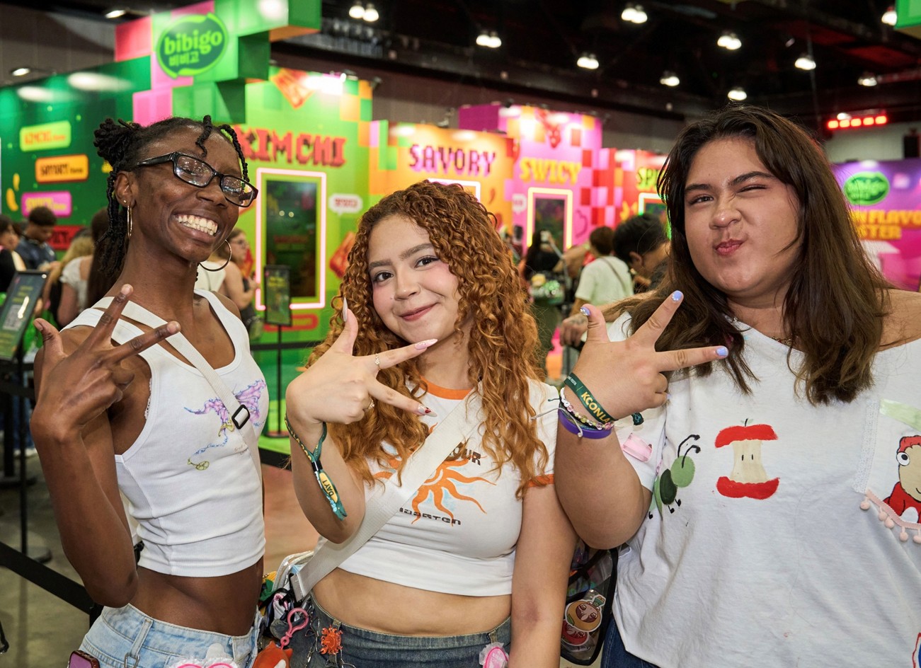'KCON LA 2026'에 마련된 비비고 부스 앞에서 관람객들이 다양한 포즈를 취하고 있다