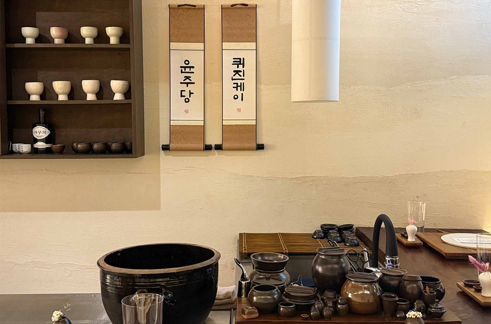 Inside the restaurant decorated with scrolls, small earthenware jars, and ceramic dinnerware